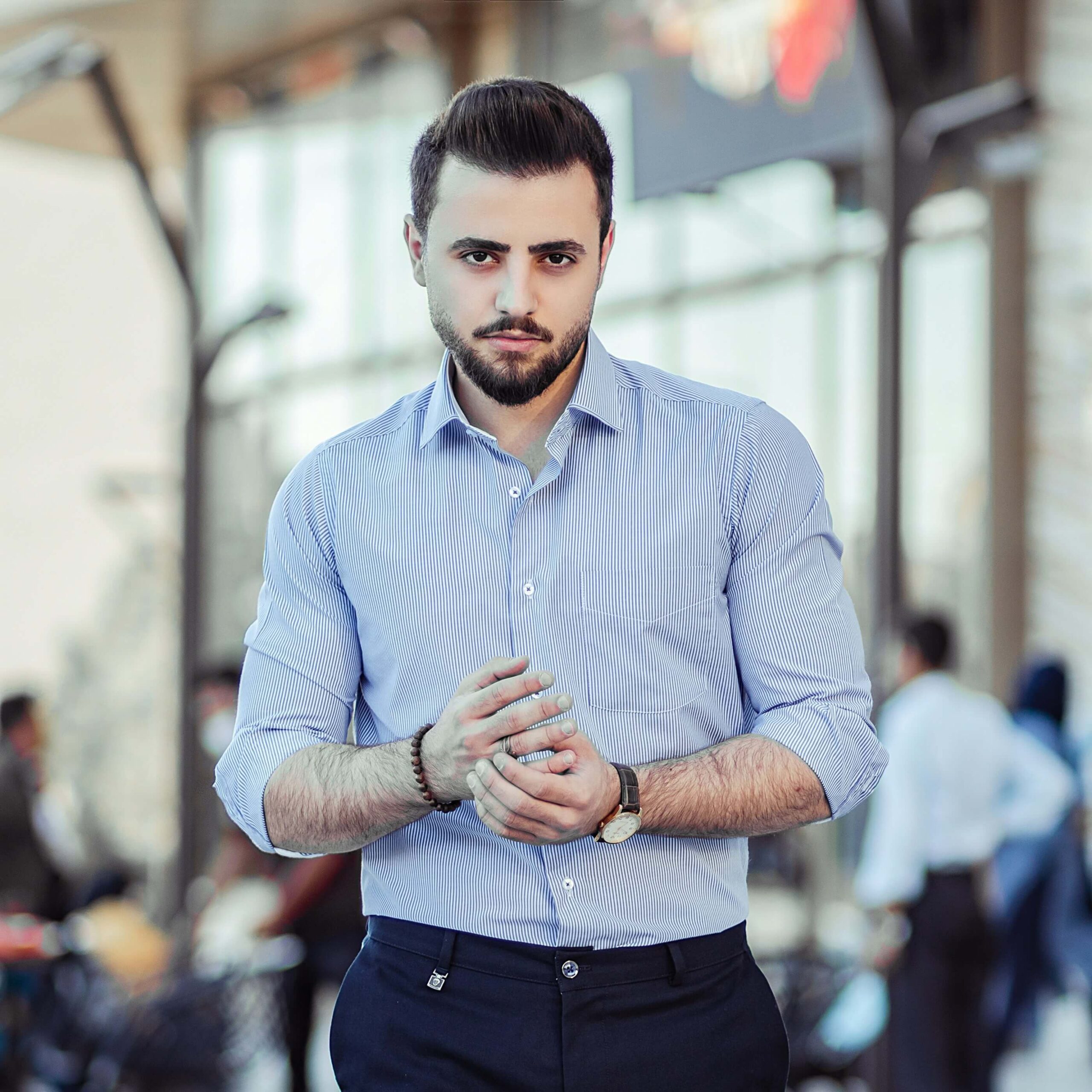 A portrait photoshoot of a man in formal professional work setting